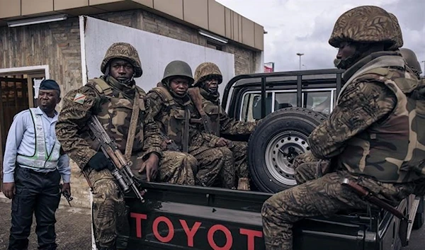 A Congolese military escort stands guard at the airport in Goma, eastern Democratic Republic of Congo, as former Kenyan president Uhuru Kenyatta lands on November 15, 2022. Source: AFP