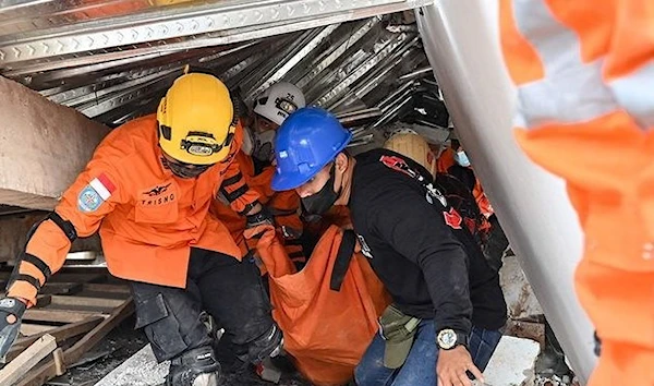 Rescue workers carry the body of a victim in Cianjur. (AFP)