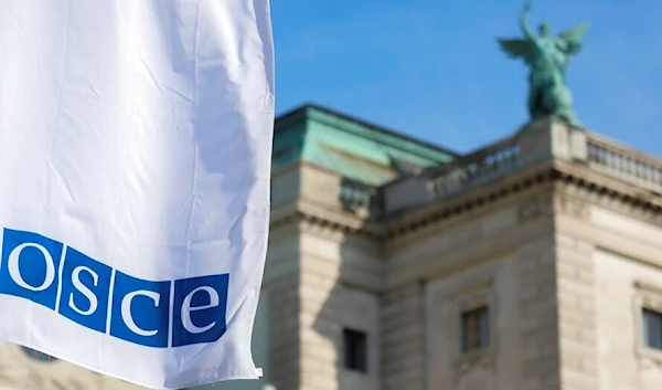 Flags wave in the wind in front of the entrance of the Permanent Council of the Organization for Security and Cooperation in Europe (OSCE).(AP)