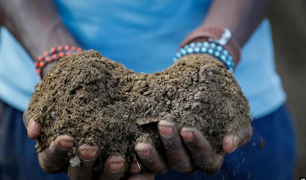 A farmer holds livestock manure that he will use to fertilize crops. (AP)