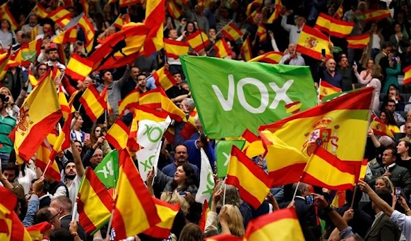 Supporters of Spain's far-right party VOX wave Spanish flags as they attend an electoral rally ahead of general elections in the Andalusian capital of Seville, Spain April 24, 2019 (Reuters)