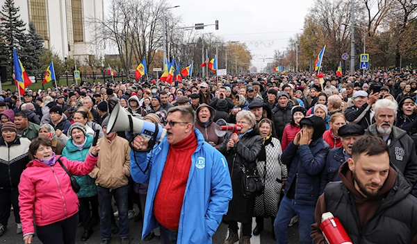 People chant slogans during a protest initiated by the populist Shor Party, calling for early elections and President Maia Sandu's resignation, in Chisinau, Moldova, Sunday, Nov. 13, 2022 (AP Photo/Aurel Obreja)