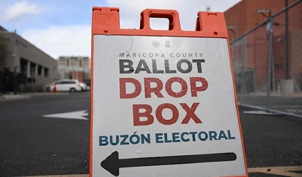 Signage directs voters to a ballot drop box for early voting outside of the Maricopa County Tabulation and Election Center ahead of the Arizona midterm elections in Phoenix, Arizona on November 3, 2022. PATRICK T. FALLON / AFP