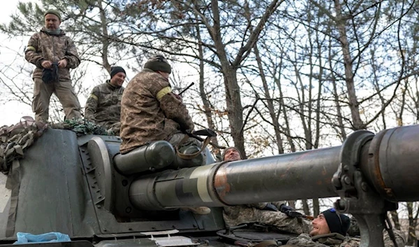 Ukrainian artillery unit members get prepared to fire towards Kherson on Oct. 28, 2022, outside of Kherson region