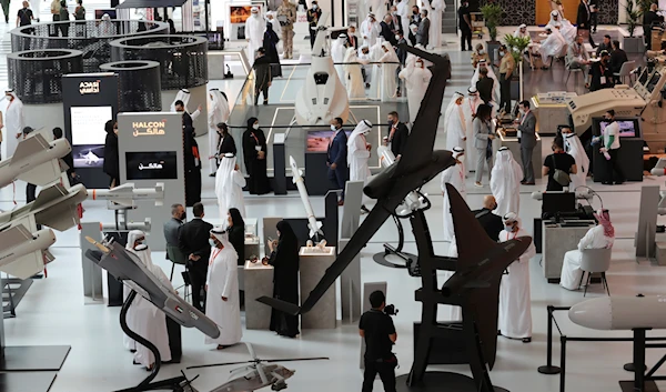 People visit military equipment on display during the opening day of the International Defence Exhibition & Conference, IDEX, in Abu Dhabi, United Arab Emirates, Sunday, Feb. 21, 2021 (AP Photo/Kamran Jebreili)