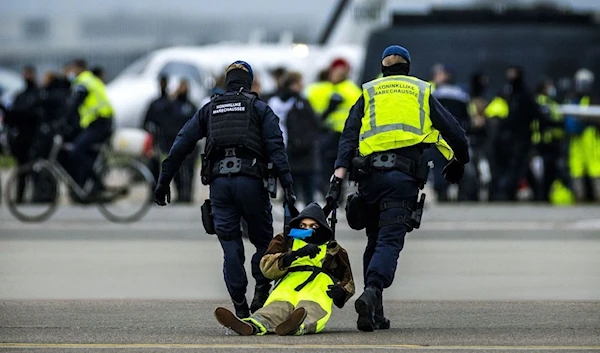 Hundreds of climate protesters staged a huge scale demonstration and blocked a runway at Schiphol airport in the Netherlands on Saturday. Source: Remko De Waal/ANP/AFP/Getty Images.