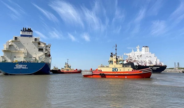 An LNG tanker is guided by tug boats at the Cheniere Sabine Pass LNG export unit in Cameron Parish, Louisiana, US.