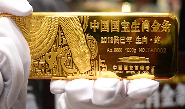 China reveals its gold reserves numbers as it attempts to reduce the proportion of USD it has (AFP)