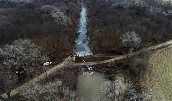 In this photo taken by a drone, cleanup continues in the area where the ruptured Keystone pipeline dumped oil into a creek in Washington County, Kan., Friday, Dec. 9, 2022. Source: DroneBase via AP.