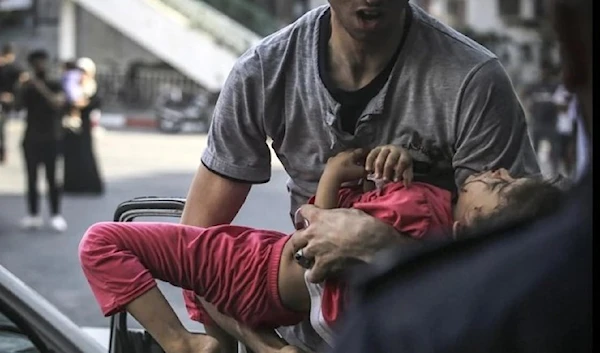 A wounded five year-old Palestinian child is rushed to hospital after an Israeli air strike on Gaza. (AFP)