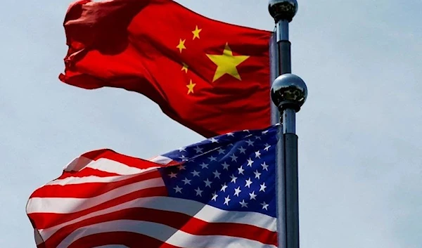 Chinese and U.S. flags flutter near The Bund in Shanghai, China (REUTERS)