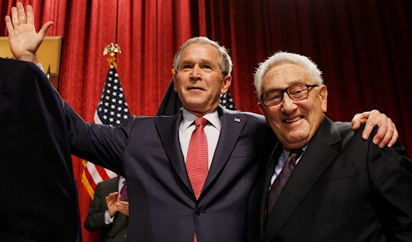 Former Secretary of State Henry Kissinger with then-President George W. Bush in New York City, March 14, 2008 (AP Photo)