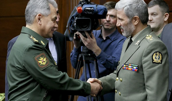 Russian Defense Minister Sergei Shoigu, left, shakes hands with meets with then-Iranian Defense Minister Amir Hatami during a meeting in Moscow, Russia, April 3, 2018 (AP Photo)