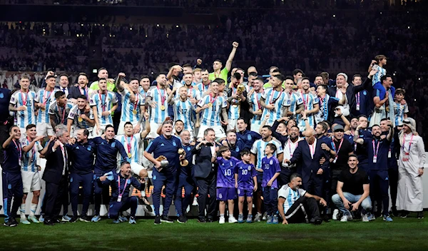 Argentina players and team staff pose after winning the World Cup final soccer match between Argentina and France at the Lusail Stadium in Lusail, Qatar, Sunday, Dec. 18, 2022 (AP Photo/Martin Meissner)