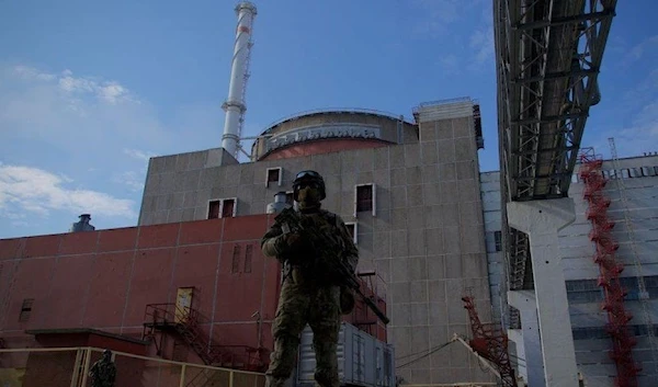 GETTY IMAGES Image caption, A Russian soldier stands guard outside Zaporizhzhia nuclear power plant