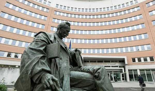 A statue is seen in front of the courthouse of in Brescia (REUTERS)