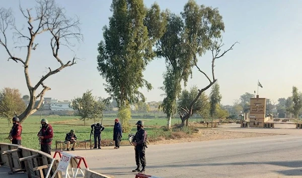 Pakistani soldiers stand guard on a road leading to the cantonment area in Bannu (Zahid Muhammad)