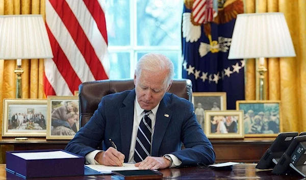 President Joe Biden signs the American Rescue Plan on March 11, 2021 (AFP)