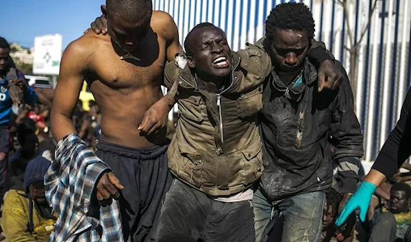 Migrants arrive at a holding centre after crossing the fences separating the Spanish enclave of Melilla from Morocco, in Melilla, Spain, Wednesday, March 2, 2022 (AP Photo)