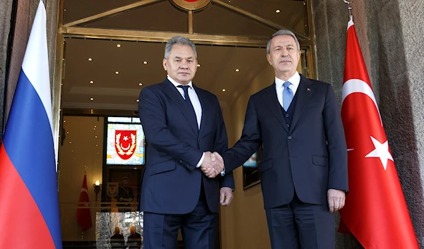 Turkish Defense Minister Hulusi Akar and Russian Defense Minister Sergei Shoigu pose for a photo during their meeting in Ankara, Turkey (AP Photo)