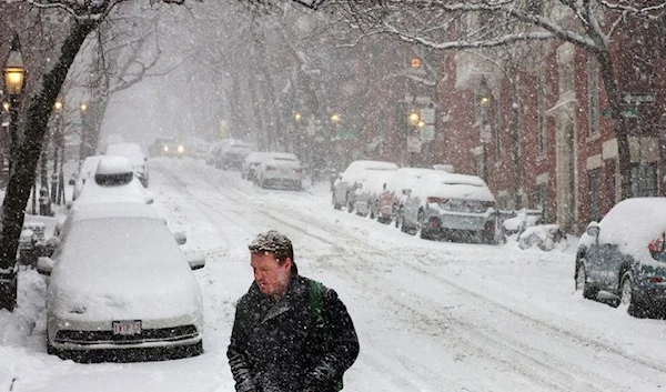 A pedestrian walks through falling snow during a winter storm in Boston, Massachusetts, U.S., February 25, 2022. (REUTERS)