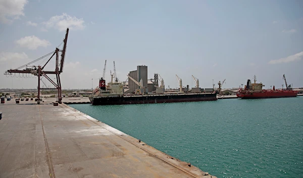 In this Saturday, Sept. 29, 2018 photo, a cargo ship and oil tanker ship sit idle while docked at the port of Hodeida, Yemen (AP Photo/Hani Mohammed)