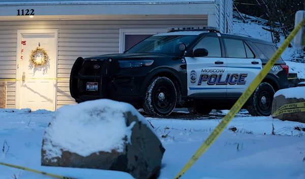 A Moscow police officer stands guard in his vehicle, Tuesday, Nov. 29, 2022, at the home where four University of Idaho students were found dead. Source: TED S. WARREN/AP