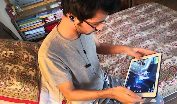 Anirudh Ishaan, 23, plays an online game PUBG on his notebook in New Delhi, India, Friday, April 5, 2019  (AP Photo/Raunaq Lekhi)