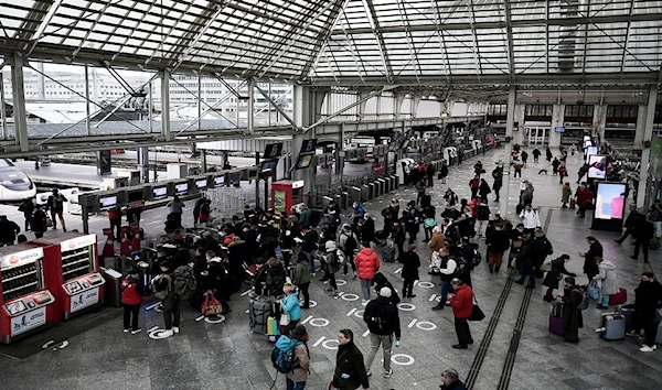 Commuters wait in line to take the train at Gare de Lyon in Paris.  (AFP)