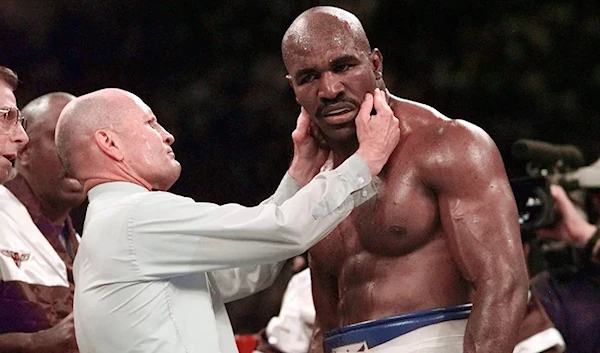 referee Mills Lane checks Evander Holyfield's right ear after he was bit by Mike Tyson during the third round of their WBA heavyweight boxing match June 28, 1997, in Las Vegas (AP)