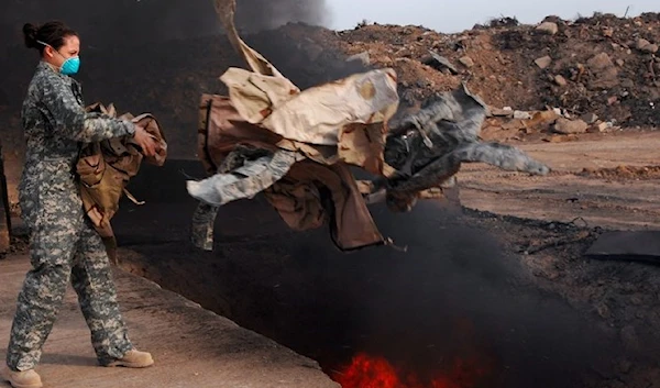 US troops in Iraq disposing uniforms in a burn pit.