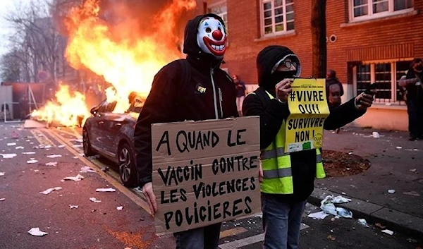 December 5, 2020: A protest which turned violent. A protester holds a sign that reads, “When is the vaccine against police violence?” (Getty Images)