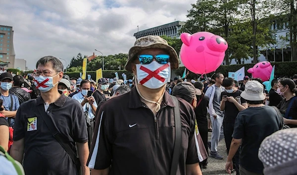 People protest against the lifting of restrictions on US pork containing ractopamine in Taipei (AFP)