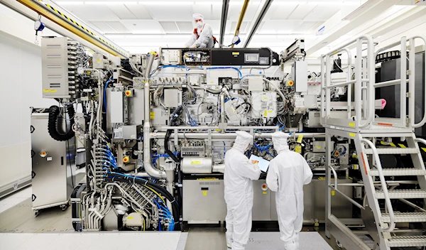 Employees are seen working on the final assembly of ASML's TWINSCAN NXE:3400B semiconductor lithography tool, Veldhoven, Netherlands, April 4, 2019 (Reuters)