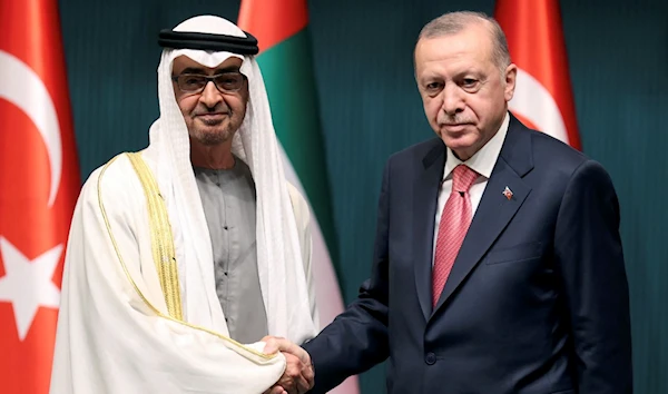 Turkish President Recep Tayyip Erdogan shakes hands with Abu Dhabi's Crown Prince Sheikh Mohammed bin Zayed Al-Nahyan in Turkey