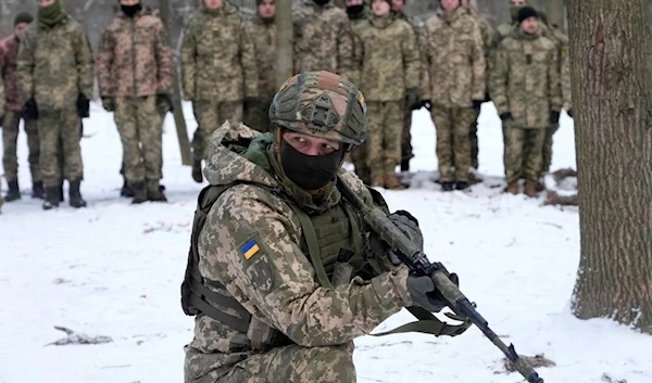 An instructor trains members of Ukraine's Territorial Defense Forces, volunteer military units of the Armed Forces (AP Photo)