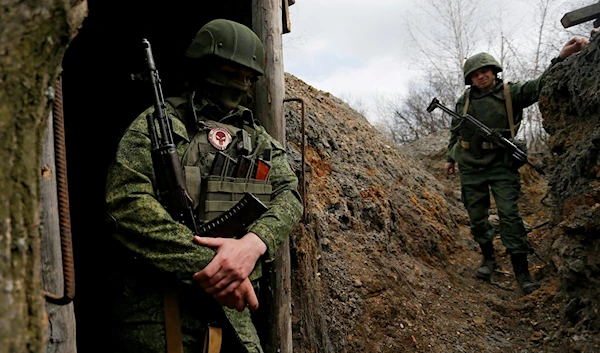 Militants of the self-proclaimed Lugansk People's Republic LNR stand guard at fighting positions on the line of separation from the Ukrainian armed forces in Luhansk, April 13, 2021