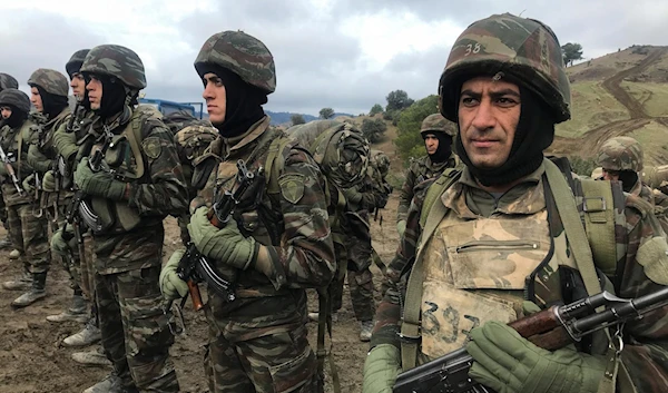 Algerian soldiers stand guard, in the Ain Defla mountains, west of the capital Algiers, Algeria January 27, 2021 (Reuters)