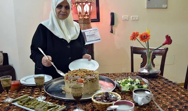 Palestinian woman with one Palestine's national dishes: maklooba