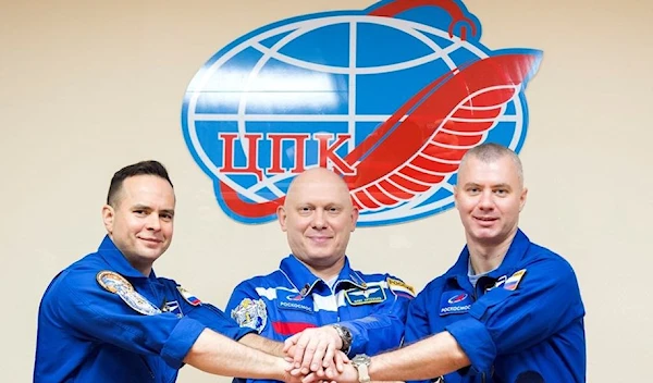 Russian cosmonauts Oleg Artemyev, Denis Matveev and Sergey Korsakov pose for a picture during a news conference ahead of the expedition to the International Space Station (ISS) at the Baikonur Cosmodrome, Kazakhstan March 17, 2022. (Roscosmos)