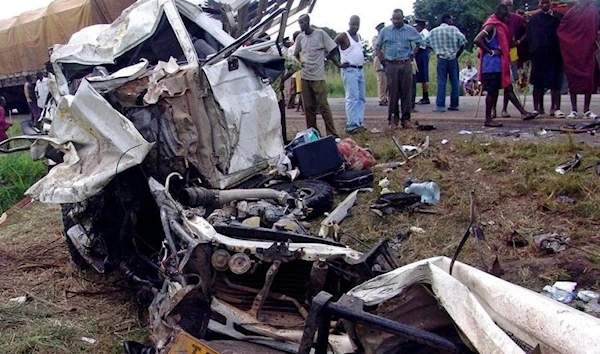 Tanzanians look at the destroyed vehicles involved in a road crash at Chamakweza in 2005. (Reuters)