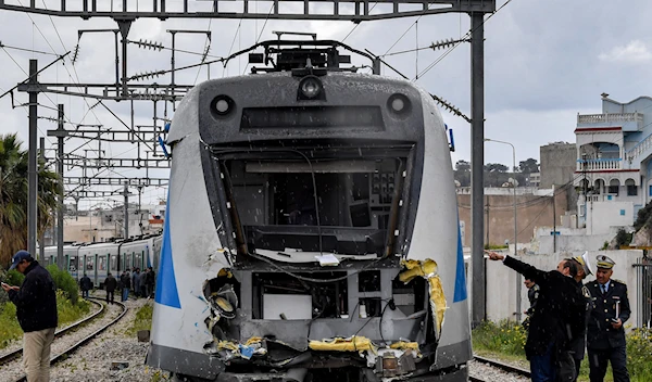 Police inspect the damage to one of the locomotives in a train collision in the Jbel Jelloud area in the south of Tunisia's capital Tunis on March 21, 2022. (AFP)