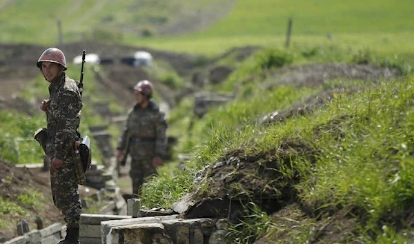 Armenian soldiers standing in a trench near Nagorno-Karabakh's town of Martuni, April 8, 2016 (Reuters)