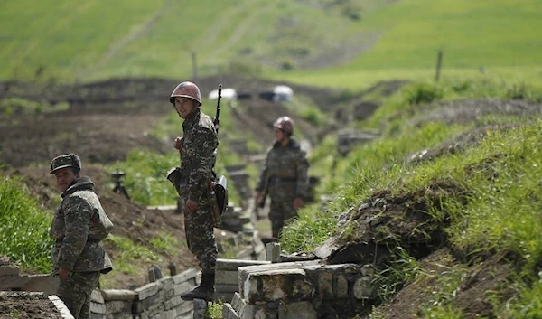 Armenian soldiers standing in a trench near Nagorno-Karabakh's town of Martuni, April 8, 2016 (Reuters)