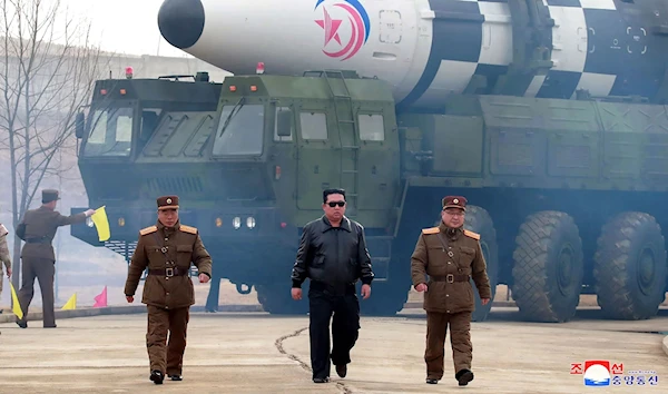 North Korean leader Kim Jong Un walks away from a missile on 24 March 2022 (Reuters)