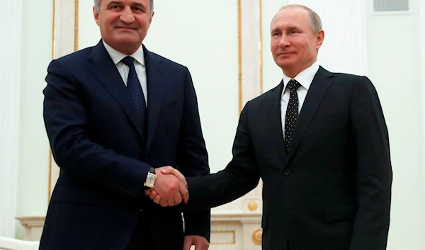 Russian President Vladimir Putin (R) shakes hands with Anatoly Bibilov, the leader of Georgia's breakaway region of South Ossetia, during their meeting at the Kremlin on March 6, 2019. PAVEL GOLOVKIN/AFP/GETTY IMAGES