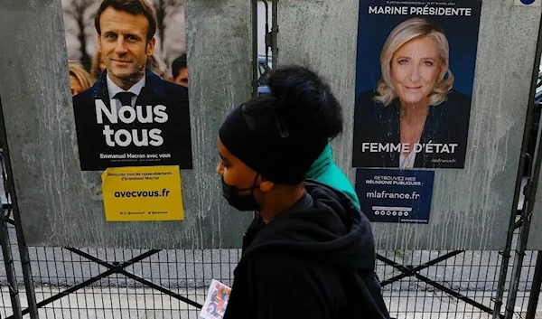 Posters of French presidential election candidates Marine Le Pen and French President Emmanuel Macron in Paris, April 4, 2022 (Reuters)