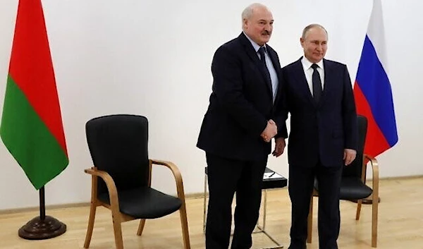 Russia's President Vladimir Putin (R) shakes hands with Belarus President Alexander Lukashenko on April 12, 2022. (Sputnik)