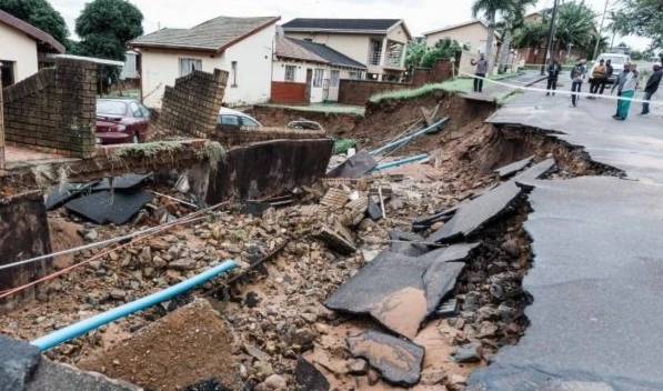 A general view of damaged home and a crack in the road following heavy rains and winds in Durban. (AFP)