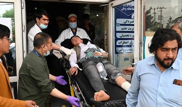 Medical staff move a wounded youth on a stretcher inside a hospital after three blasts rocked a boys' school in Kabul on April 19, 2022. (AFP)